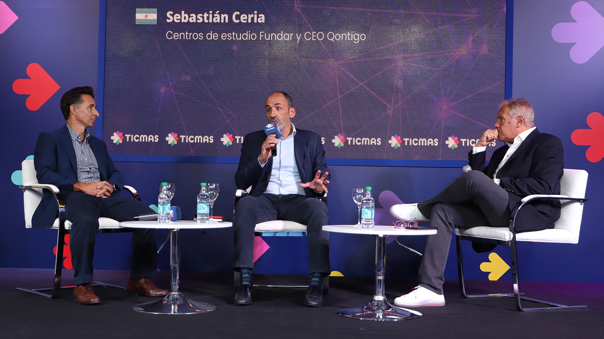 Roberto Souviron, left, listens as Sebastián Ceria speaks alongside Daniel Hadad at the Ticmas education seminar in Buenos Aires.