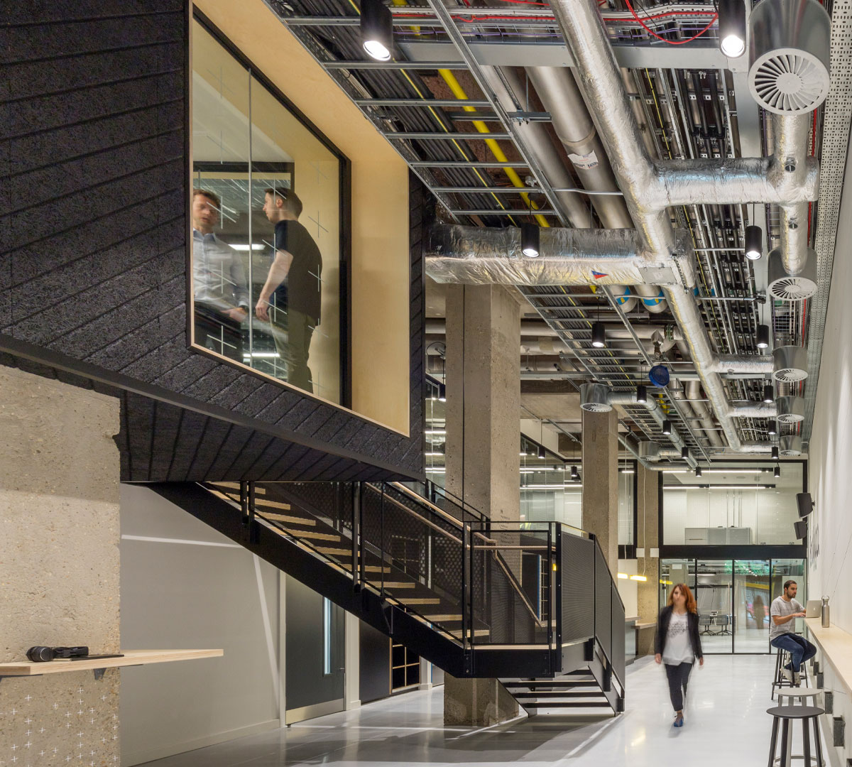 Exposed ducts, suspended meeting rooms and a staircase inside RocketSpace’s London campus