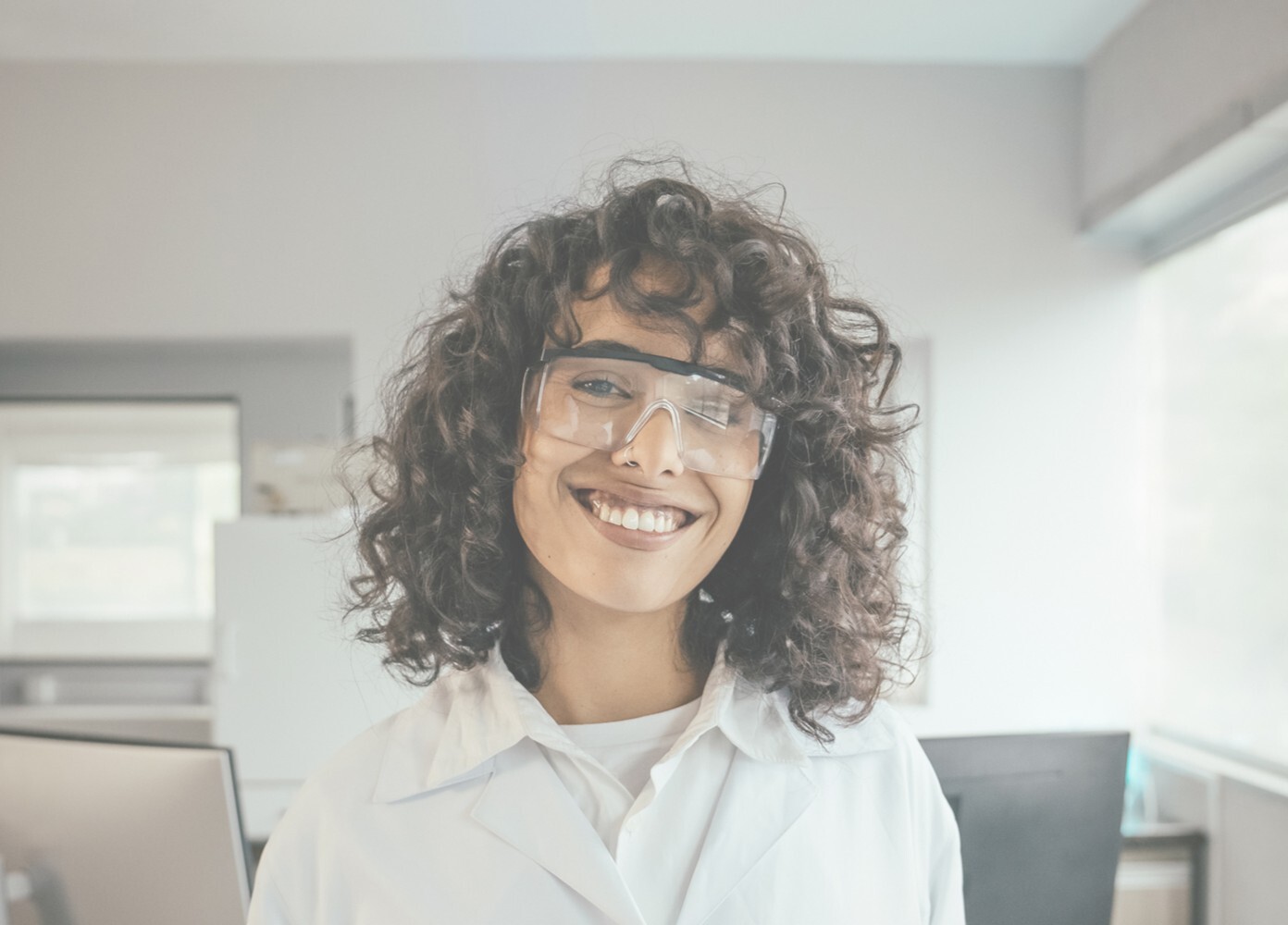 A laboratory researcher wearing safety glasses