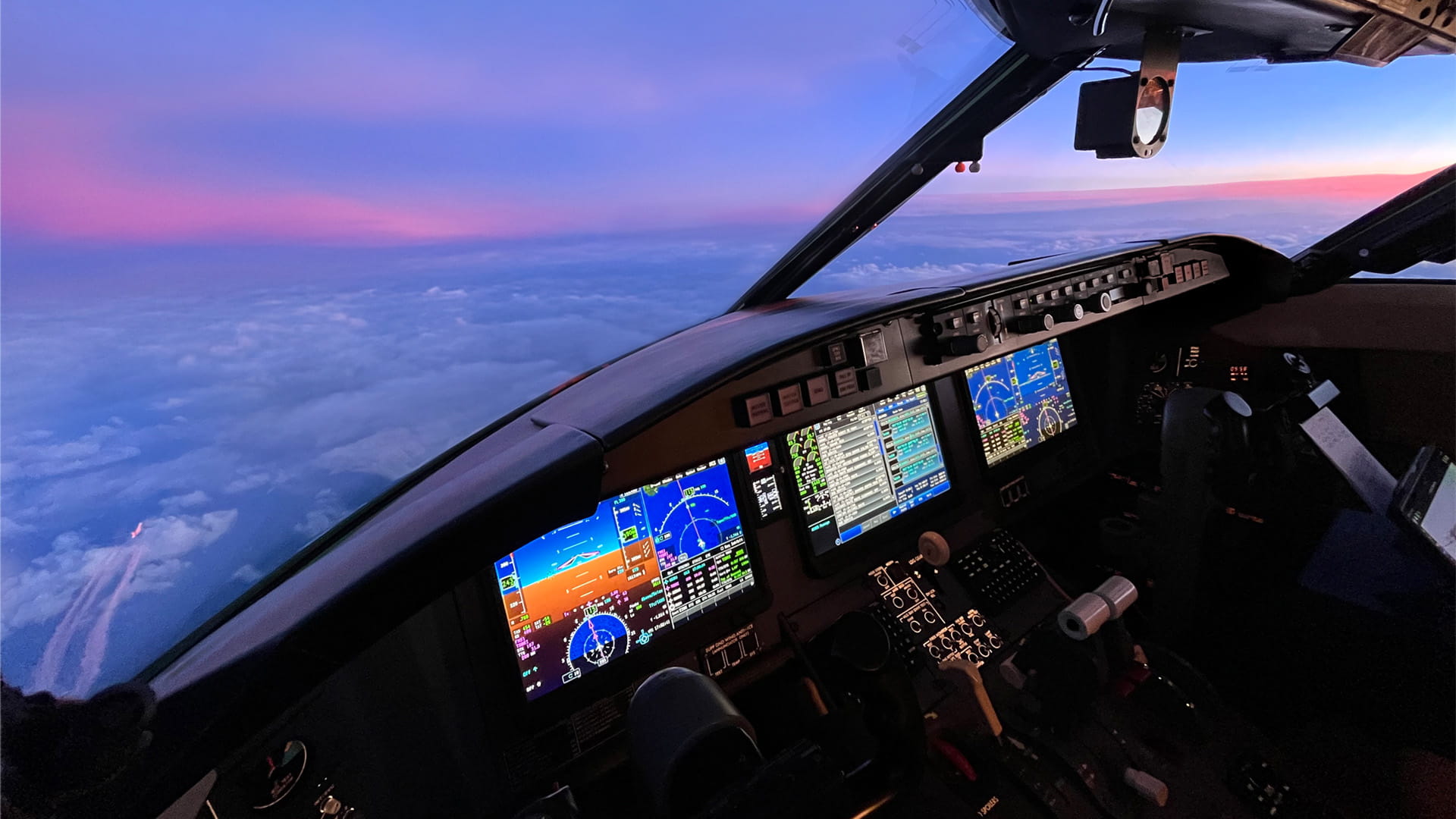 Pro Line Fusion cockpit displays illuminated beneath a pink and blue sky