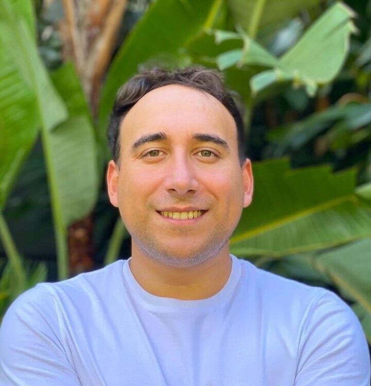 Rodrigo Vidal outdoors in front of broad green leaves