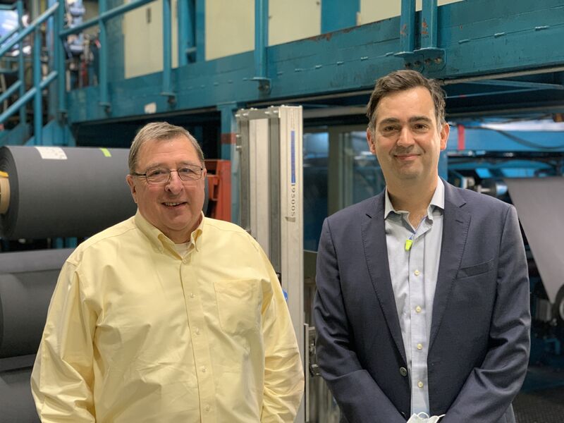 Roger Masse, left, and Guy Ebbrell, right, standing beside equipment at AvCarb in 2022