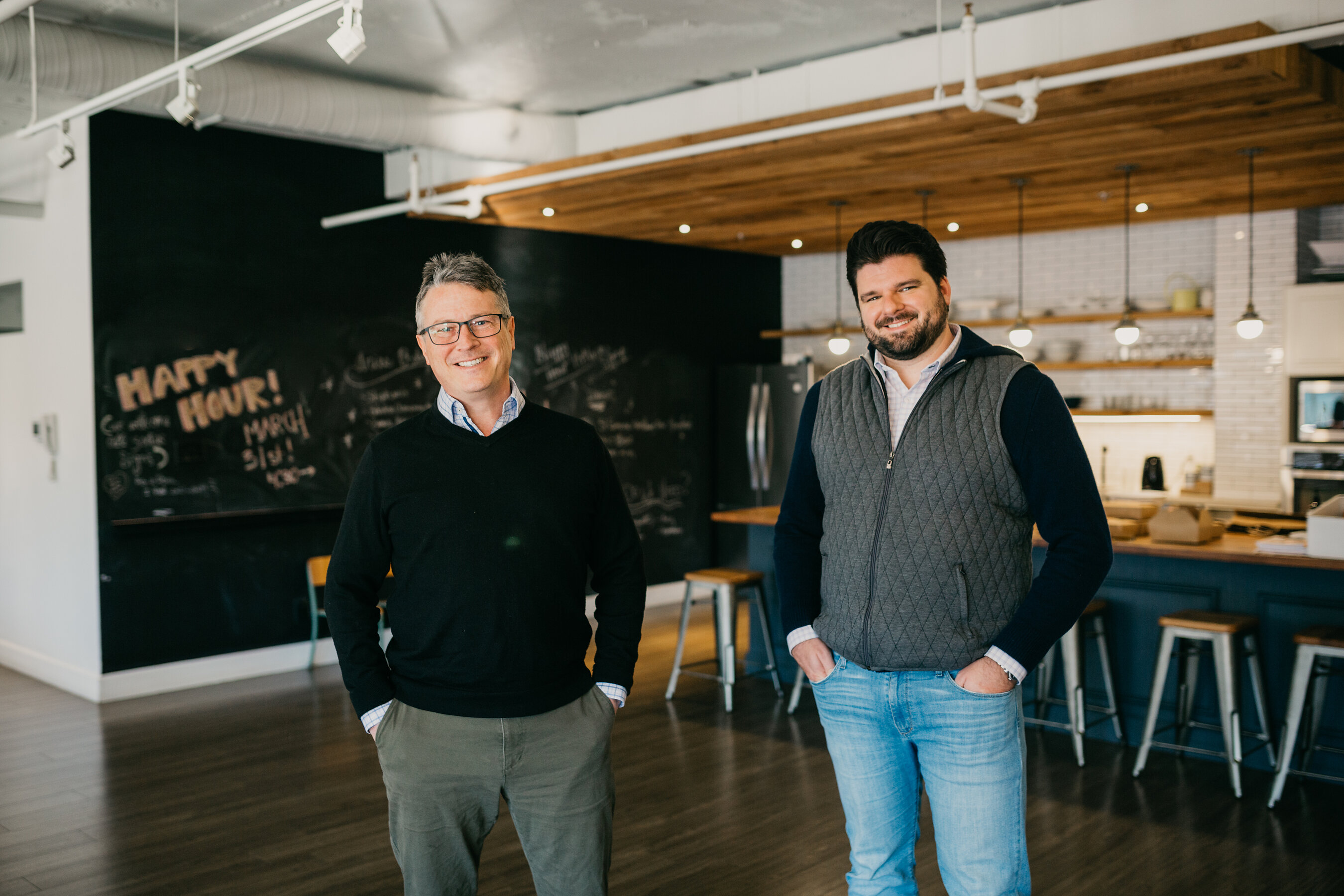 Roger Patterson, left, and Lyle Stevens standing together in a bright café interior