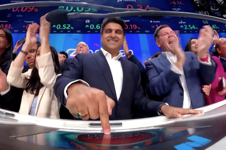 Rohan Malhotra presses the Nasdaq closing-bell button as colleagues applaud around him.