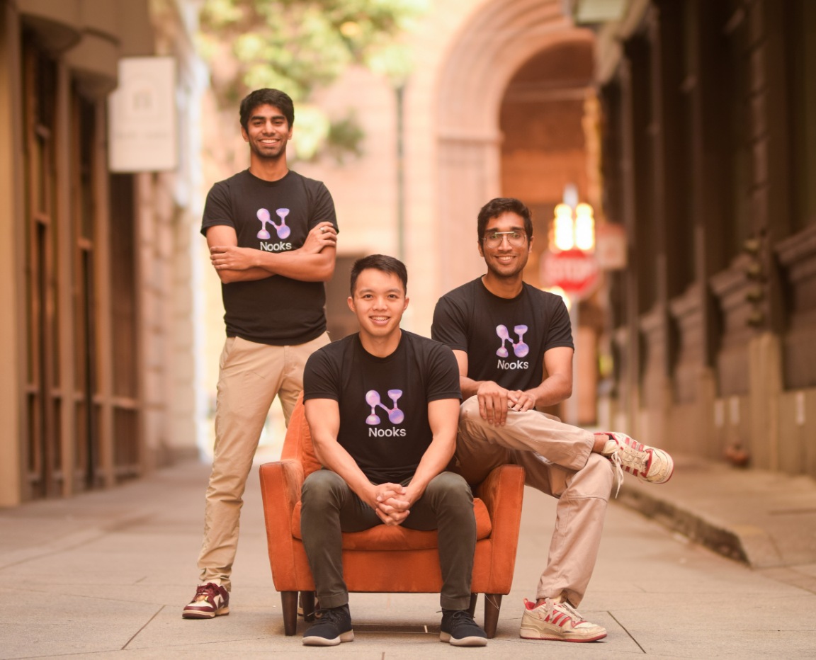Nooks co-founders Rohan Suri, Dan Lee and Nikhil Cheerla wearing Nooks shirts in a city alley