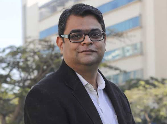 Rohit Kulkarni outdoors in a dark jacket, in the press photograph used by IReC 2019