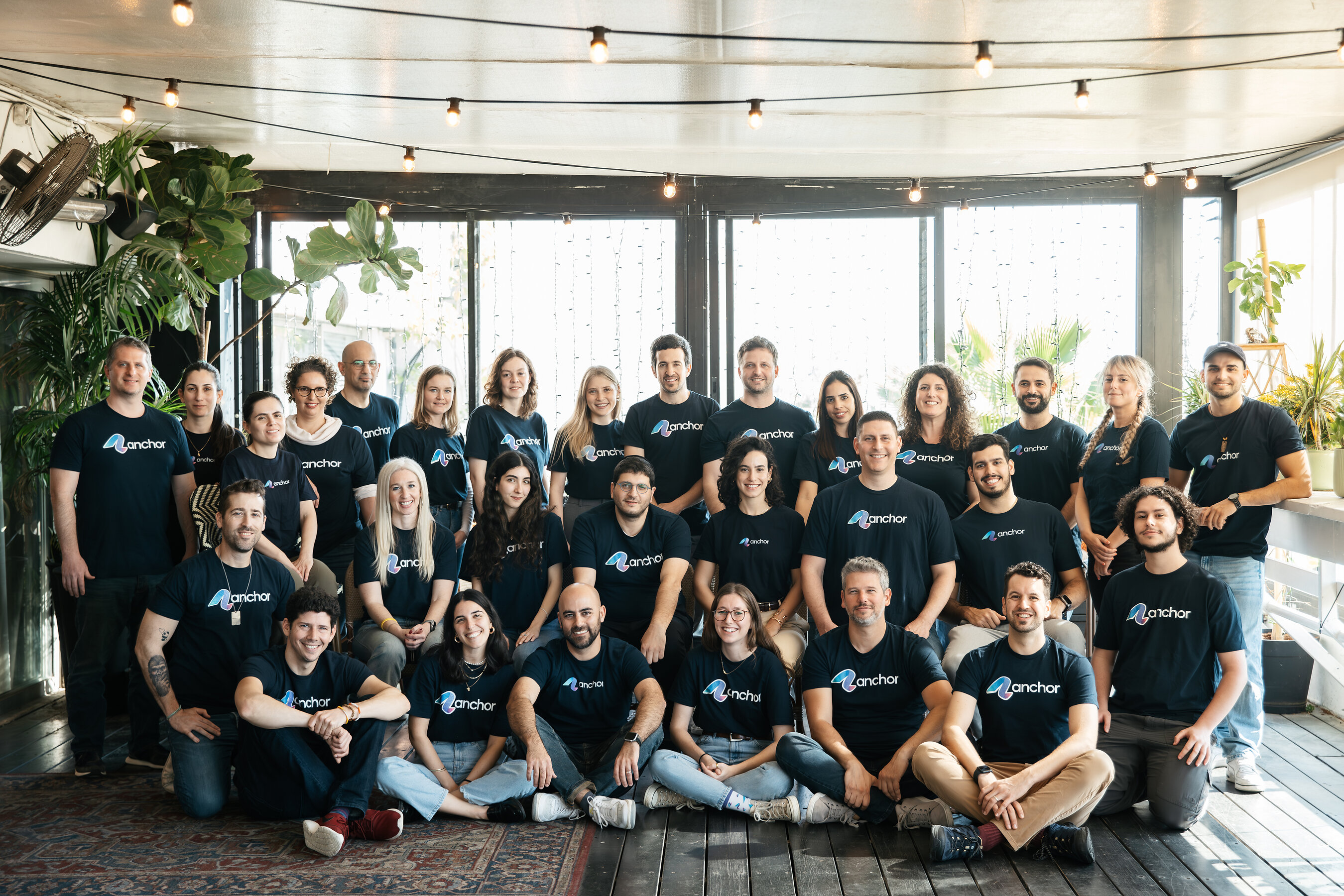 The Anchor team gathered together in matching Anchor shirts