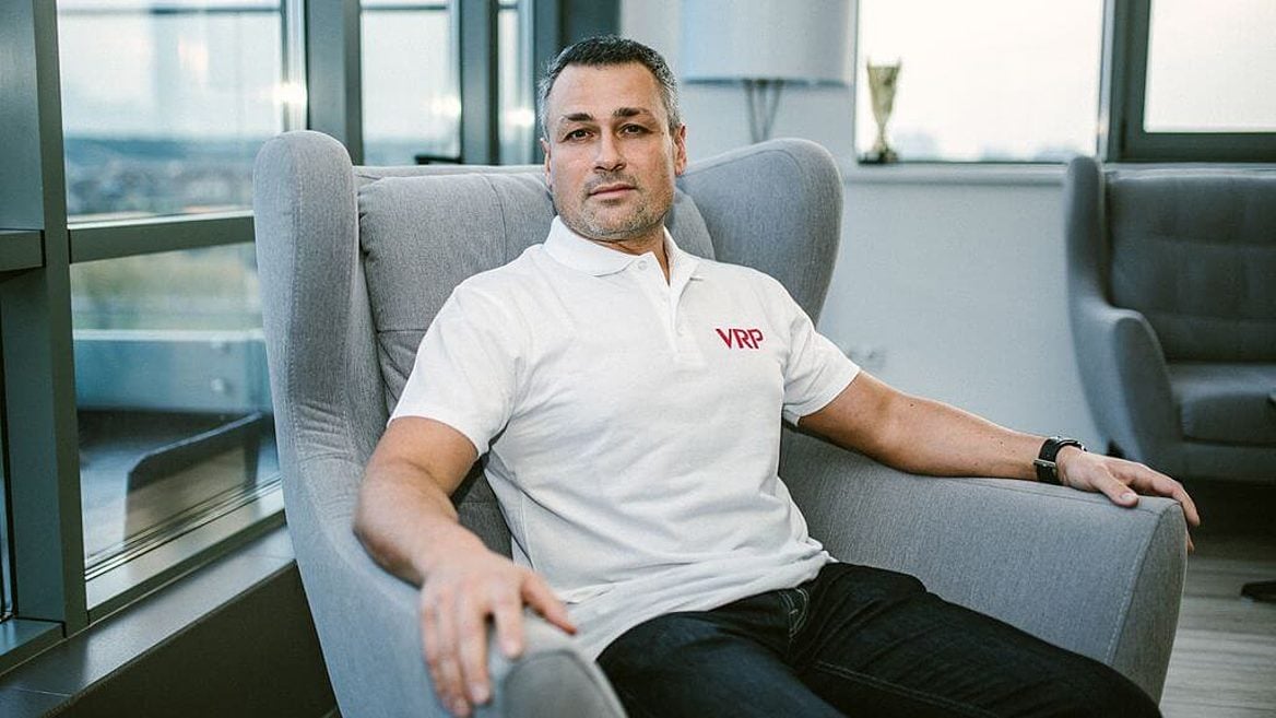 Roman Medvedev seated in an office armchair wearing a VRP polo shirt