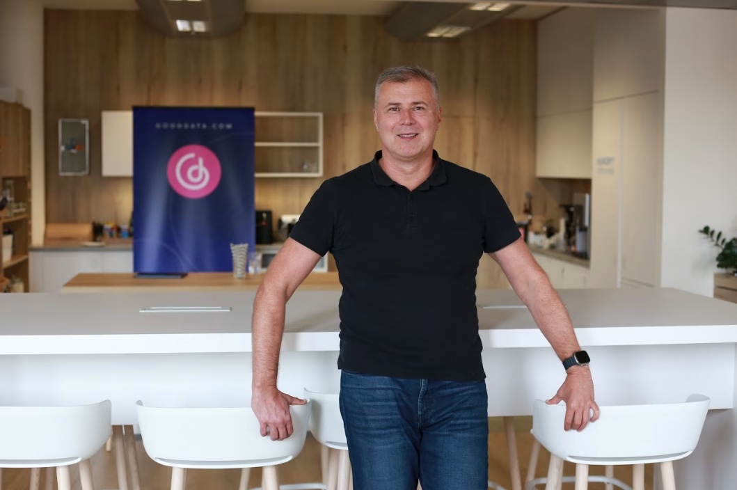 Roman Stanek standing beside chairs in a GoodData office kitchen