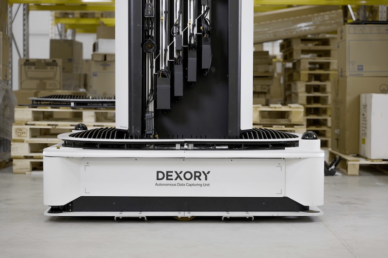 A Dexory inventory-scanning robot in a warehouse aisle
