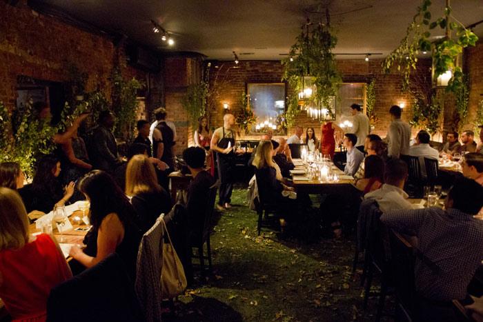 Guests at Swoop’s 2014 client dinner in the plant-filled dining room at Restaurant Marc Forgione
