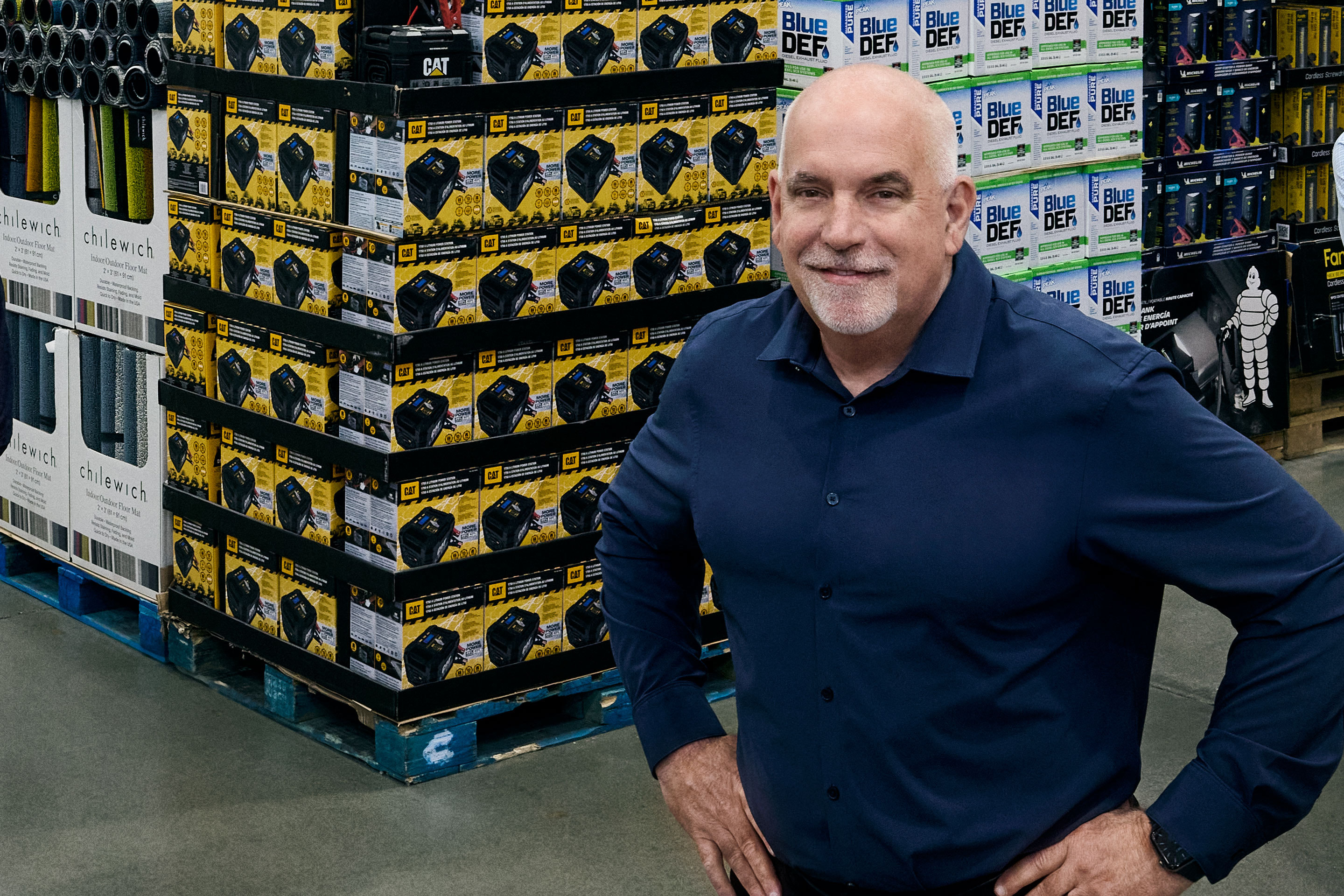 Ron Vachris standing beside stacked merchandise in a Costco warehouse