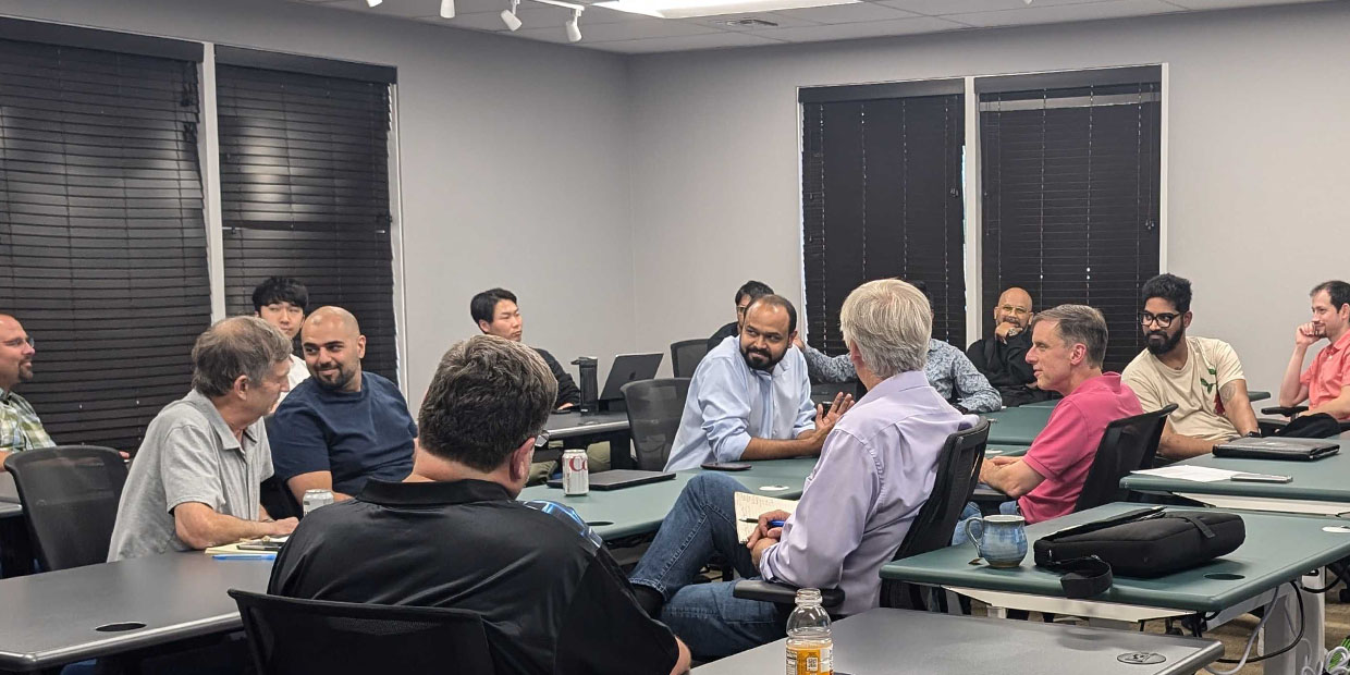 Participants talking around tables at a Venture Mechanics workshop