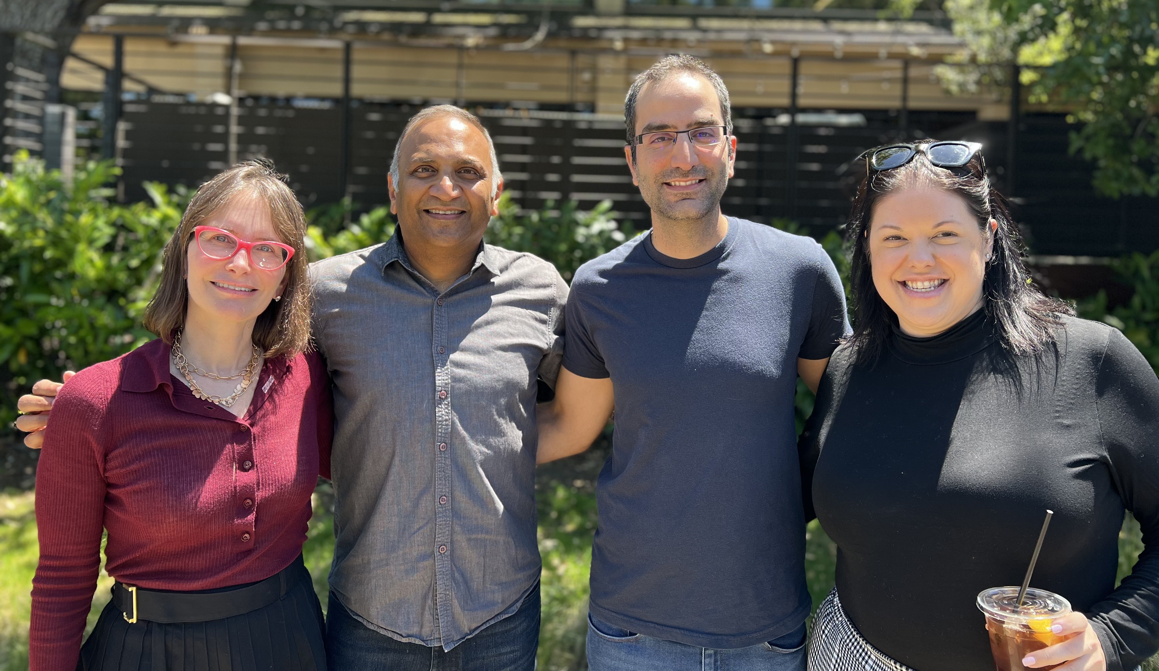 Ronak Vyas standing outdoors with three Lead colleagues
