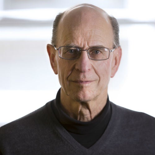 Ron Schilling wearing glasses and a dark sweater in a published press photograph