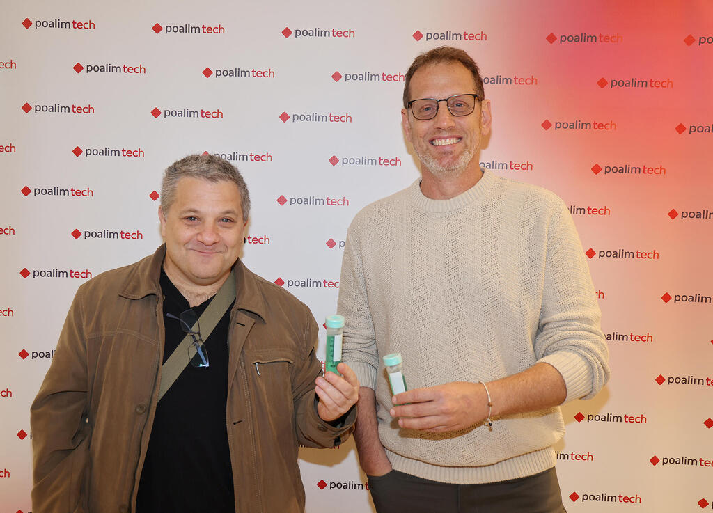 Gilad Lando, left, and Ronen Lavi, right, holding sample tubes at the Growth+ founder meeting