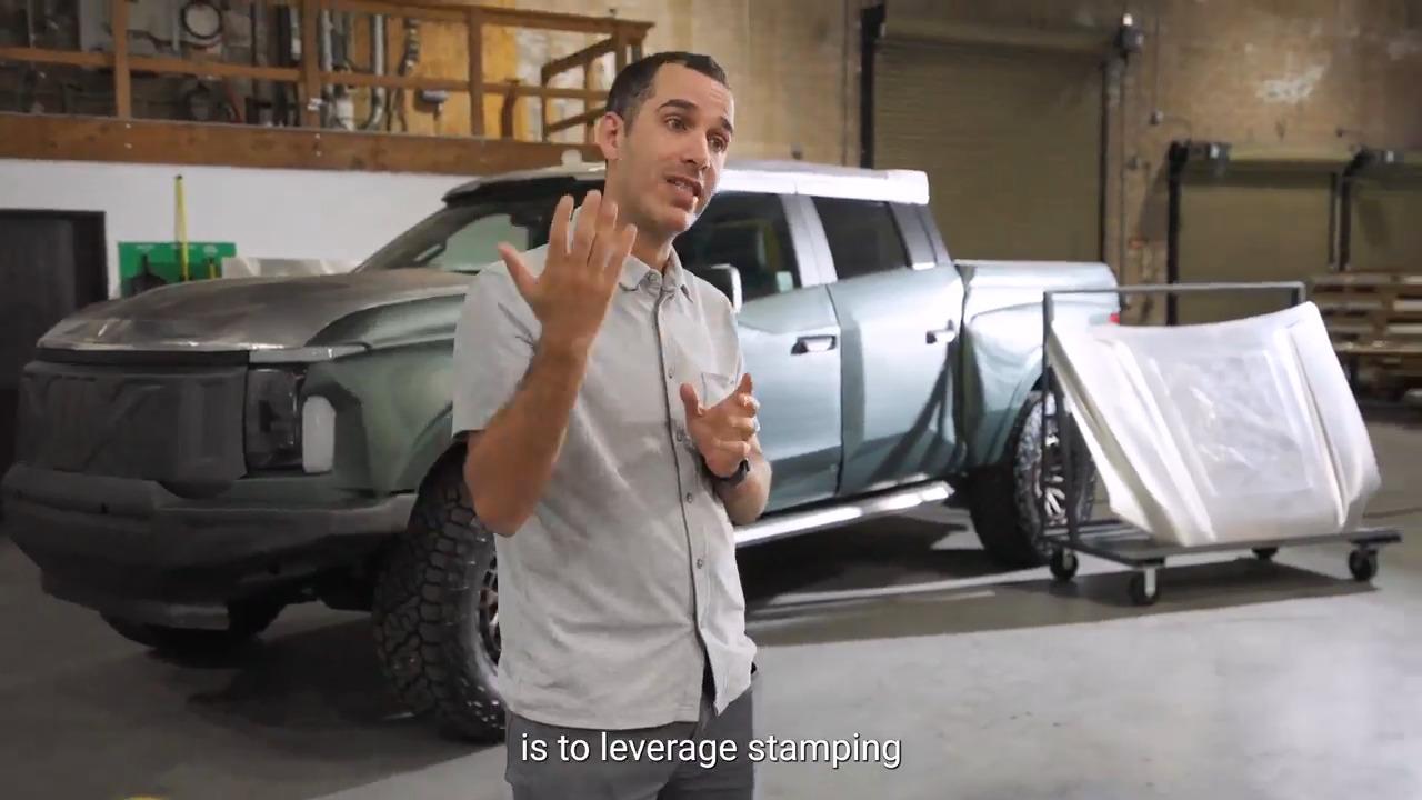 Ronen Lebi speaking on the Machina Labs factory floor beside a custom Ford F-150