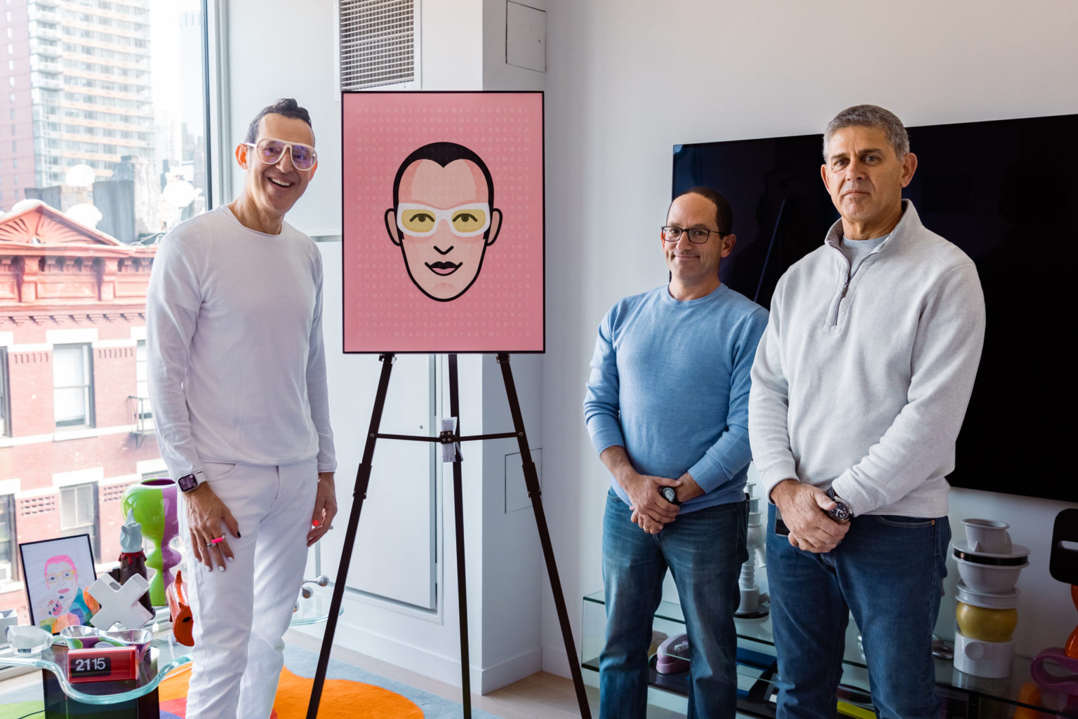 Karim Rashid, Arnon Gilboa and Ronen Shilo standing beside a pink Motiva artwork
