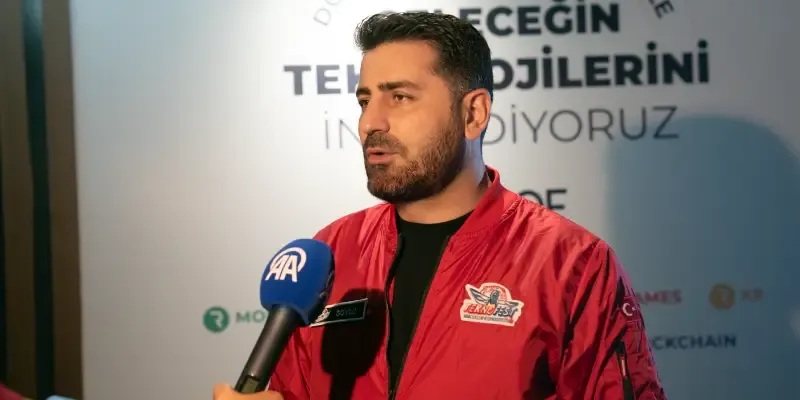RoofStacks founder Burak Soylu speaking into an Anadolu Agency microphone at TEKNOFEST