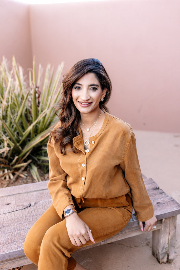 Roohi Jeelani seated outdoors in a brown outfit