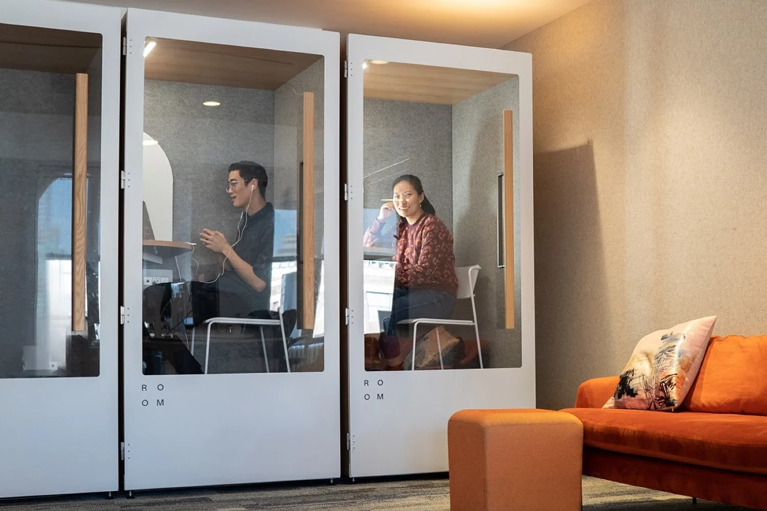 Two ROOM phone booths inside Braze's office, with people using the private spaces