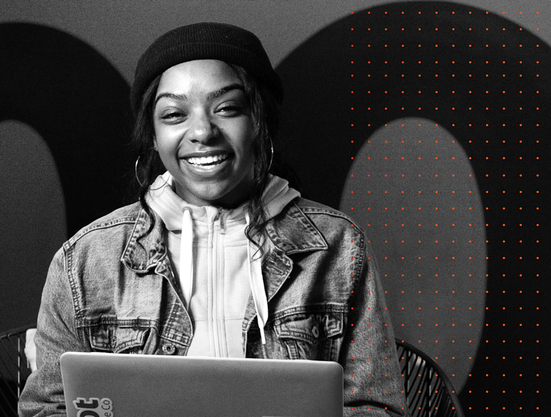 A smiling person with a laptop in Root’s careers photography