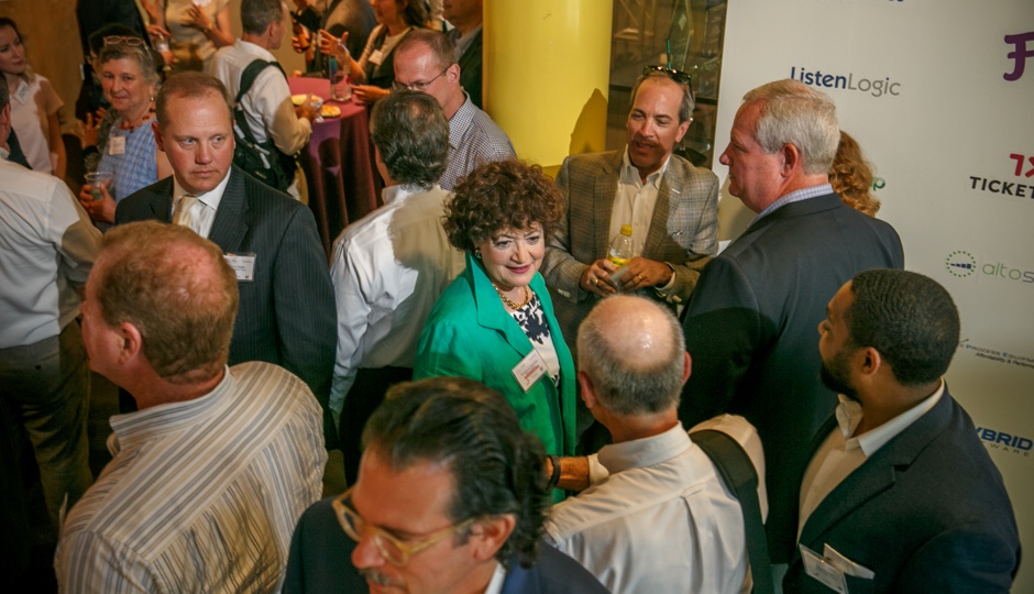 RoseAnn Rosenthal in a green jacket among attendees at an ImpactPHL event