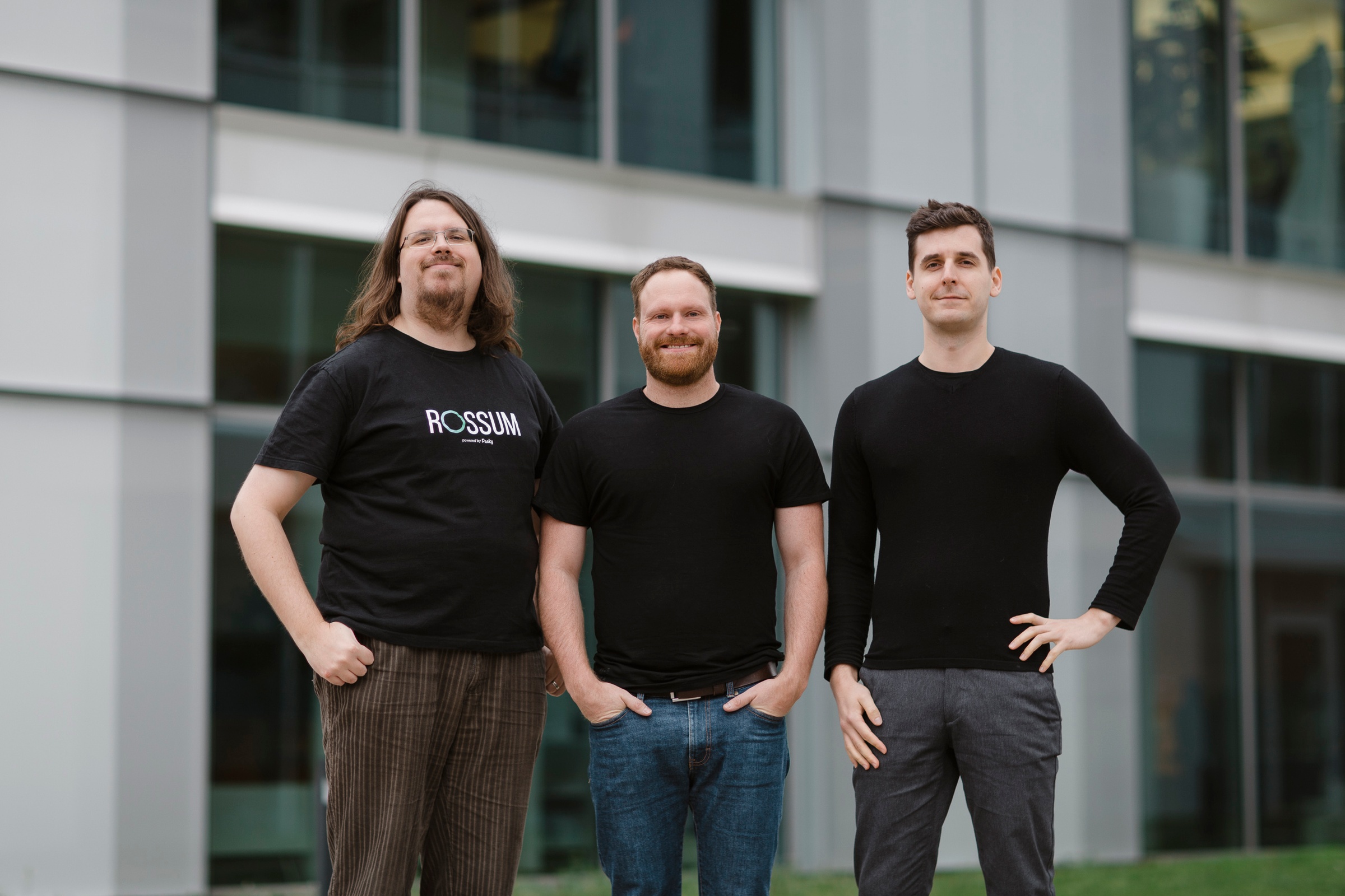 Rossum co-founders Tomáš Gogár, Petr Baudiš and Tomáš Tunys standing outside an office building