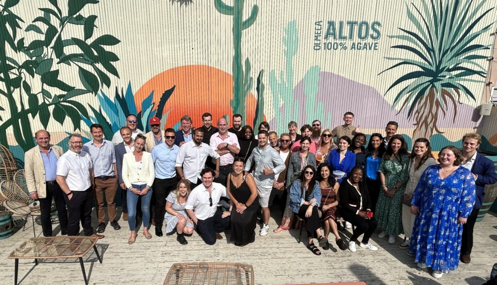 Roxhill team posing together outdoors in front of a colourful mural