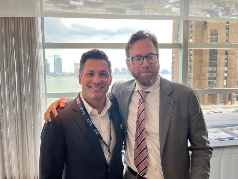 Scott Parker, left, and Roy Bejarano, right, standing together at SCALE’s 2023 leadership conference.