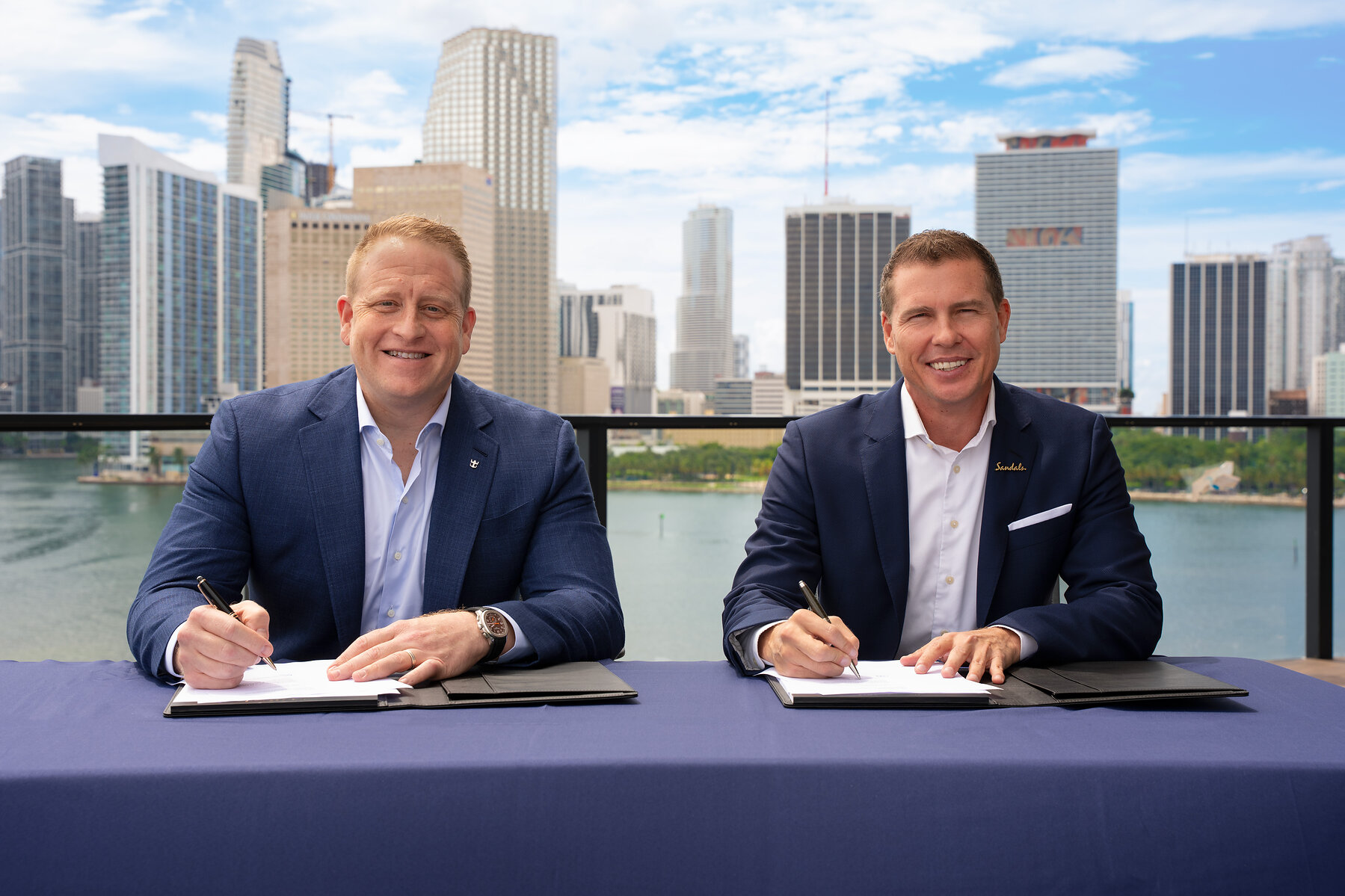 Jason Liberty and Adam Stewart mark the Royal Caribbean Group and Sandals partnership agreement in Miami