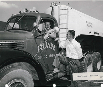 Archival photograph of two men beside a Ruan tanker truck