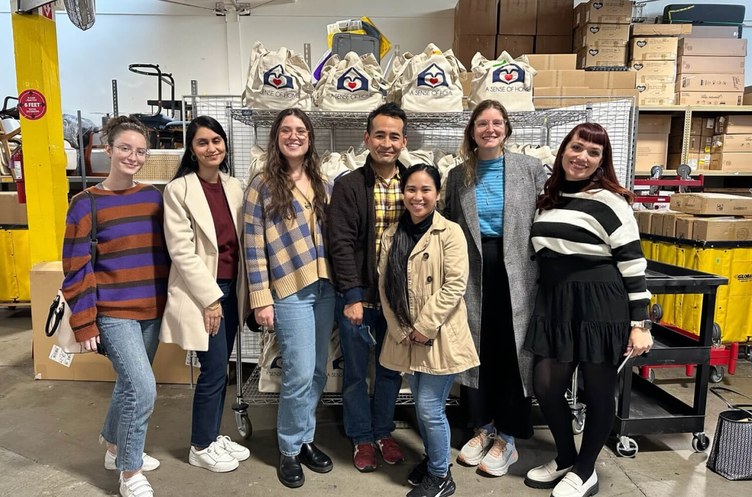 Group pictured on Ruggable’s careers page standing beside A Sense of Home donation bags