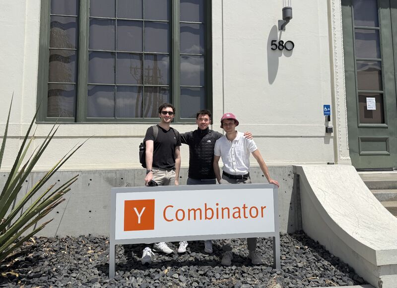 Ray Liao, center, with his two cofounders behind a Y Combinator sign
