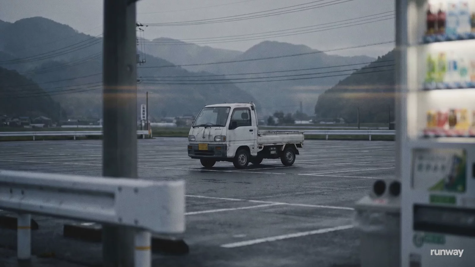 A small truck in a rainy parking lot, an official still from Runway's Aleph 2.0 product page