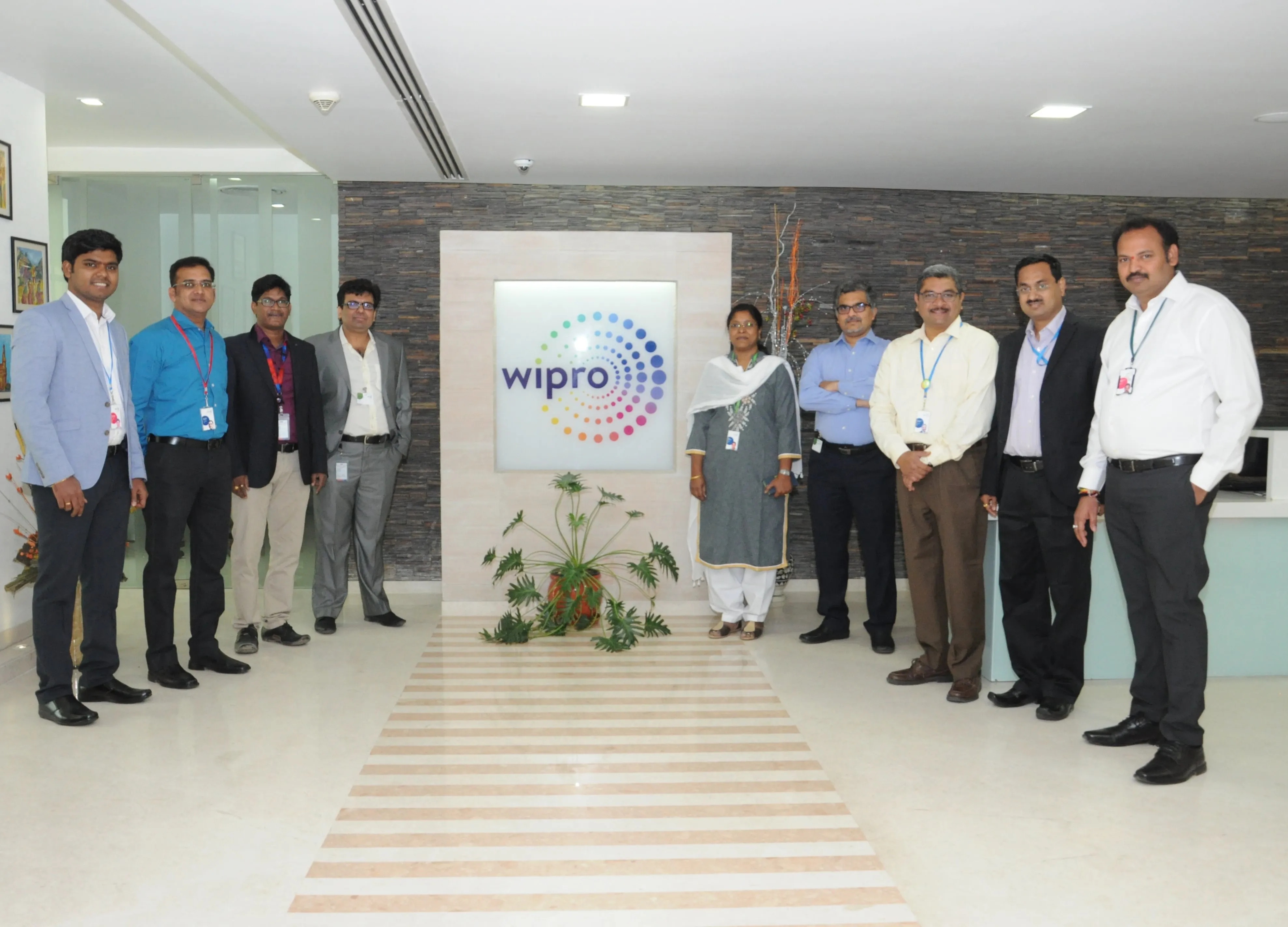 A workplace group photograph at Wipro, included in Rupesh Garg’s career gallery