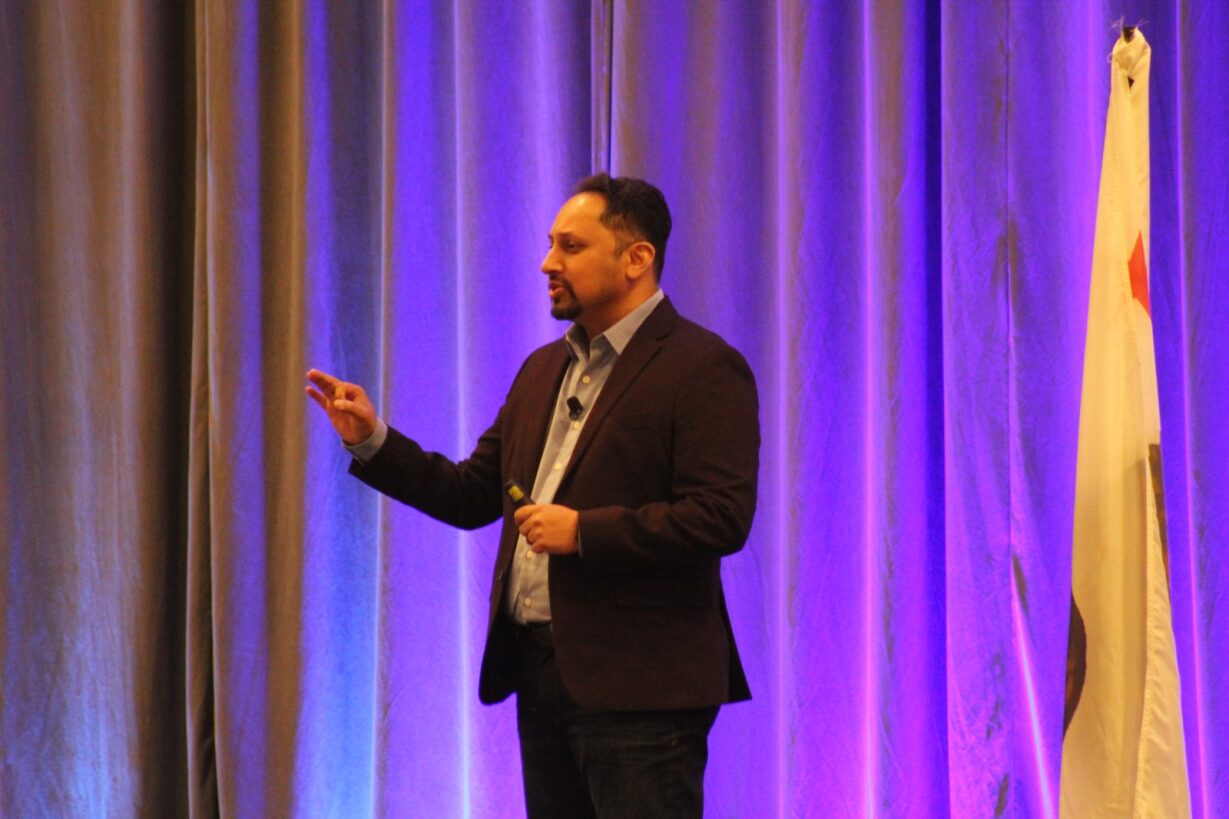 Rushang Shah speaking onstage at the 2024 HawkSoft User Group conference
