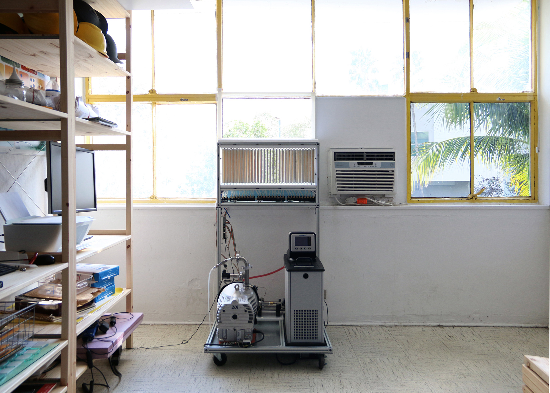 A Trellis Air prototype beside a conventional air conditioning unit during testing in Miami.
