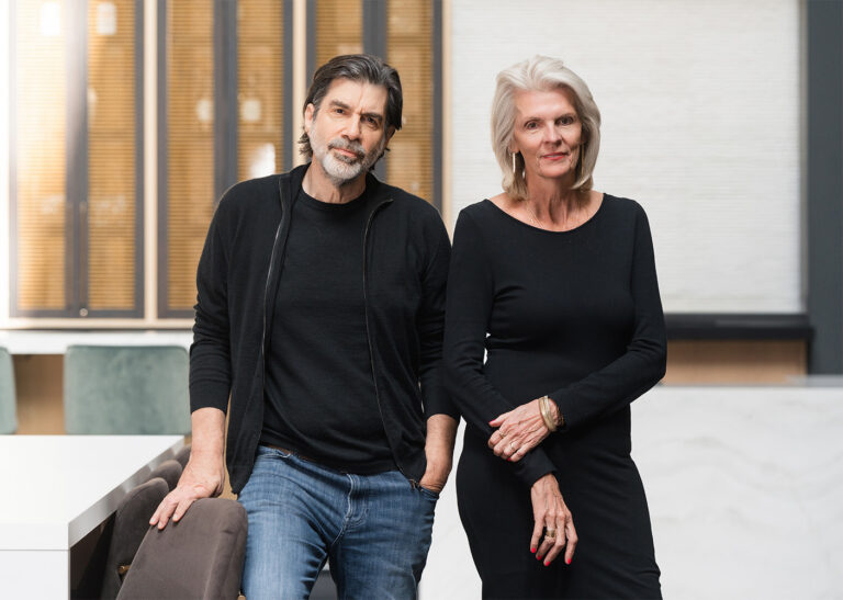 Russell Herder co-founders Brian Herder and Carol Russell standing in their Minneapolis office