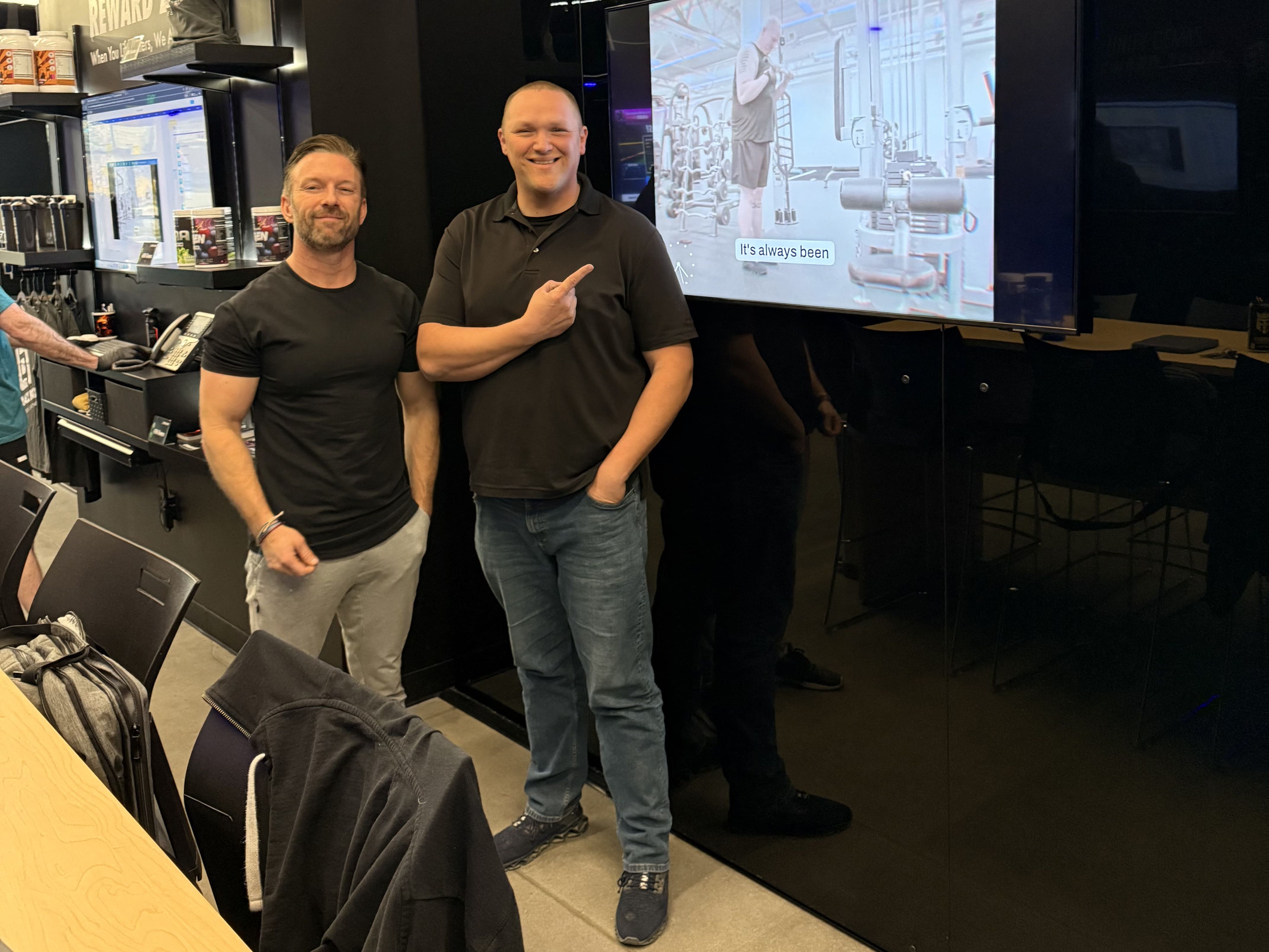 Ryan DeLuca, at left, posing beside a Black Box VR display
