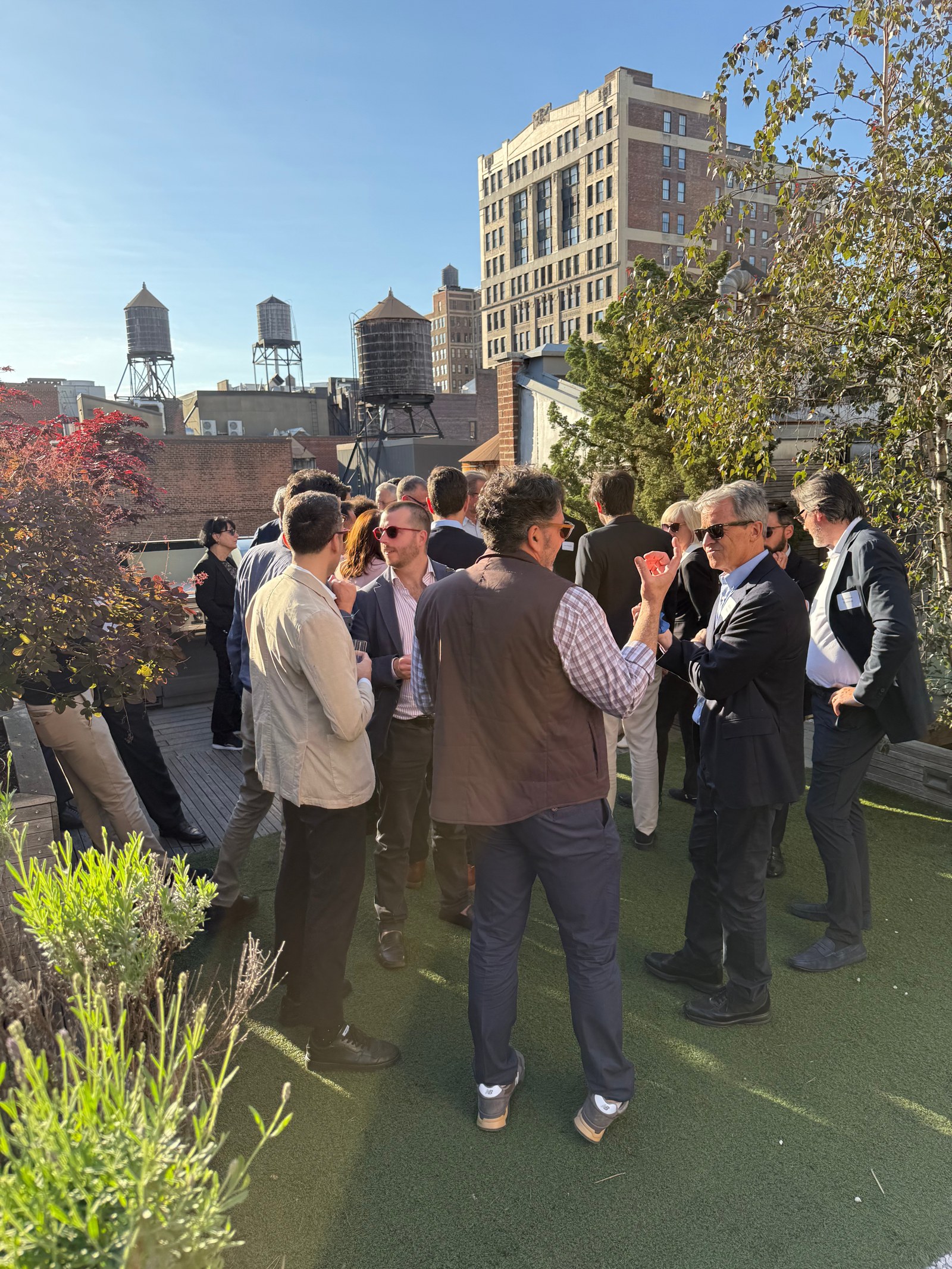 Guests talking at a Manhattan rooftop gathering pictured in the Electric feature