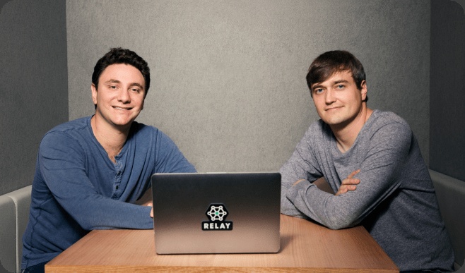 Spencer Barkoff on the left and Ryan Droege on the right, seated at a table with a Relay laptop