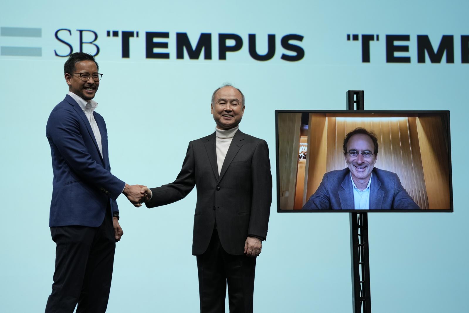 Ryan Fukushima shakes hands with Masayoshi Son, with Eric Lefkofsky joining on a screen.