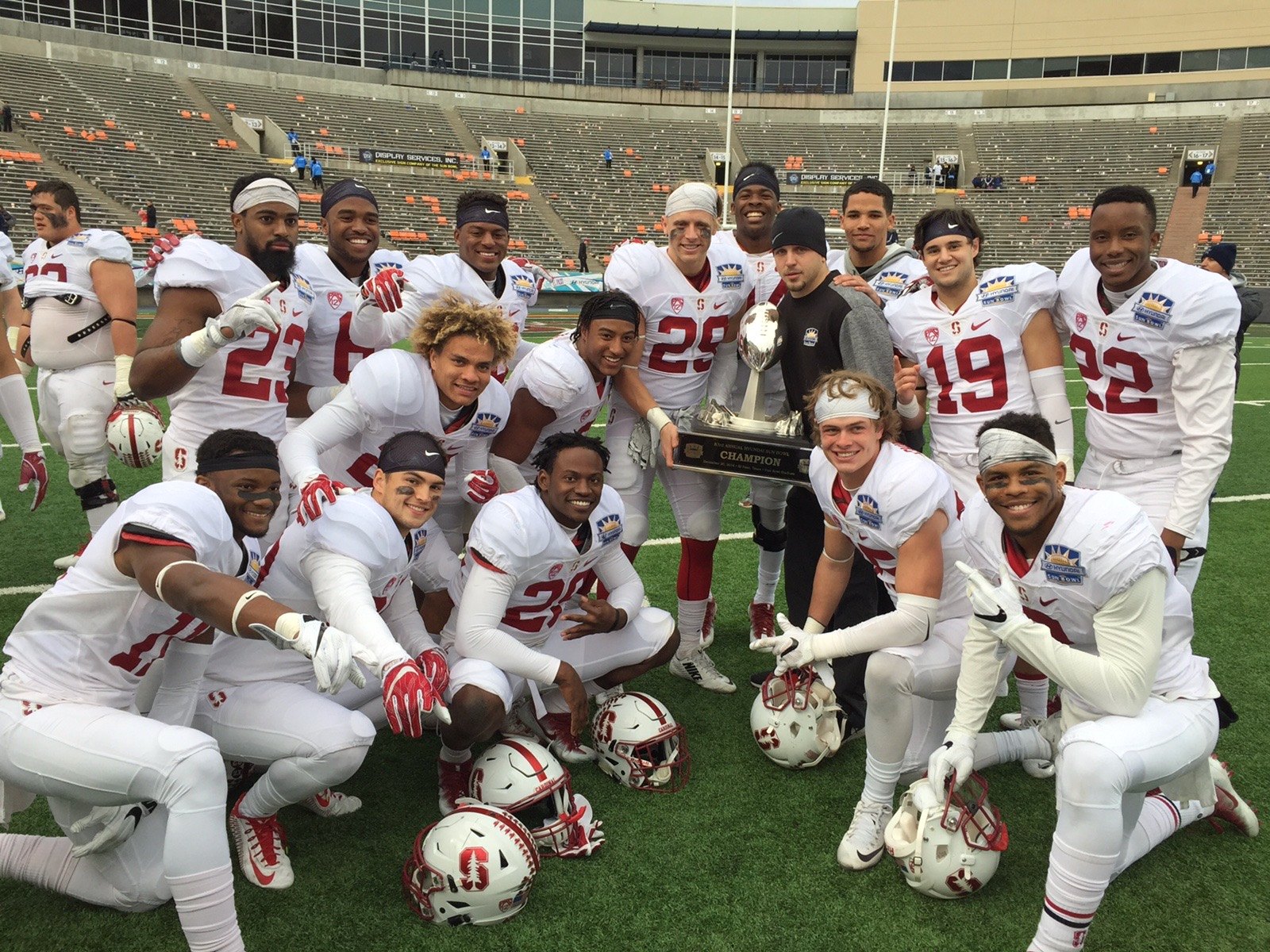 Ryan Gaertner with Stanford football teammates and a championship trophy