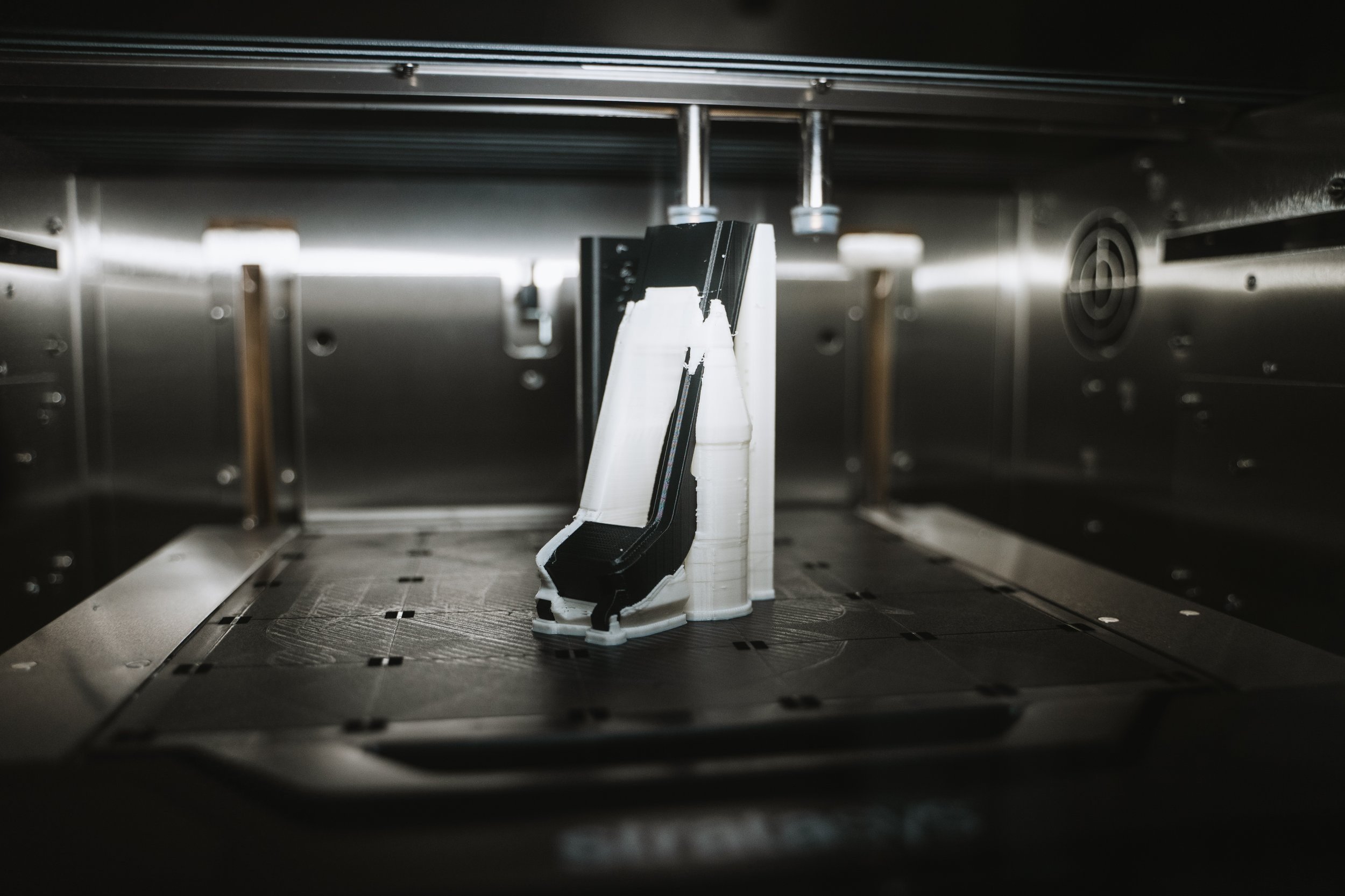 A printed component and its support material on a 3D printer’s build platform