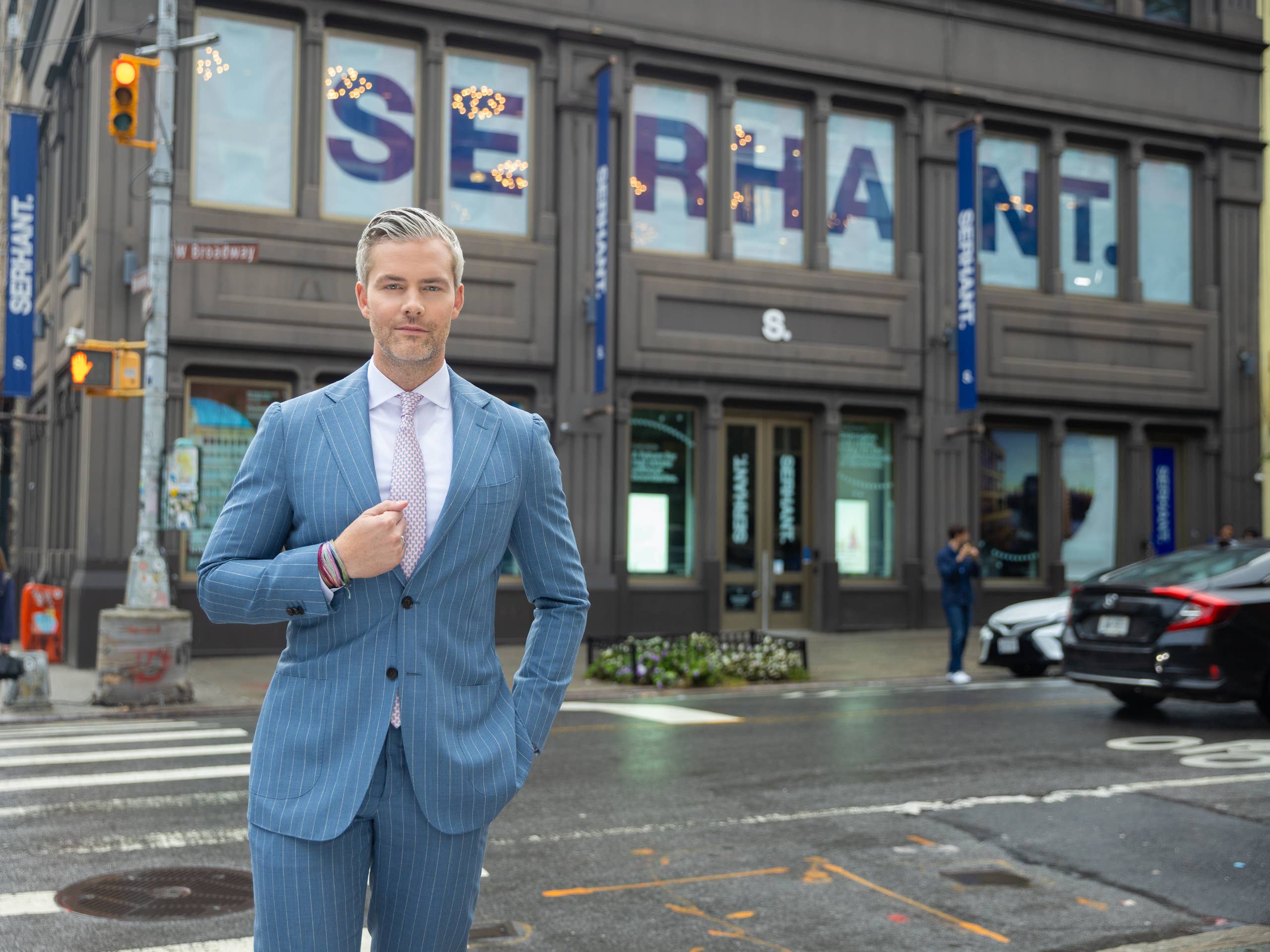 Ryan Serhant outside the SERHANT. office on a New York street