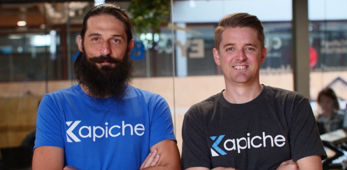 Kapiche co-founders Kris Rogers, left, and Ryan Stuart, right, wearing company T-shirts