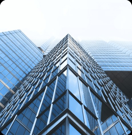 A glass commercial tower photographed from below