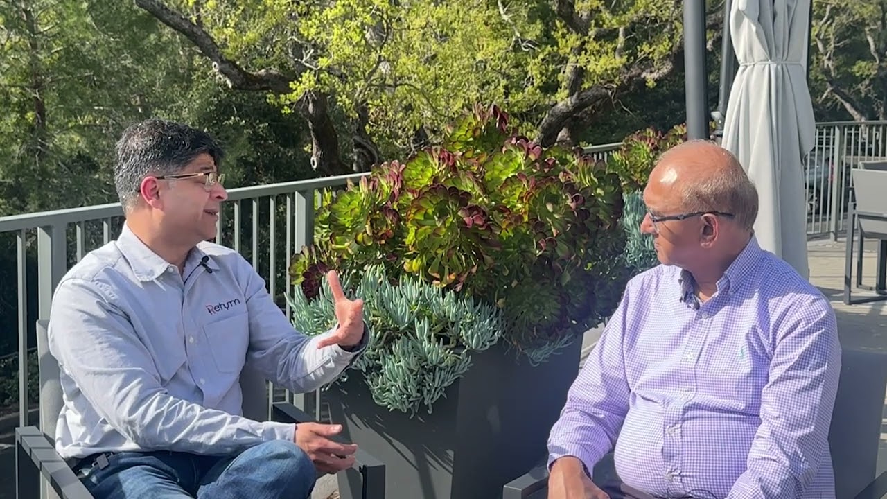 Sachin Gandhi, left, speaking with EE Times journalist Nitin Dahad outdoors for an OFC 2025 interview