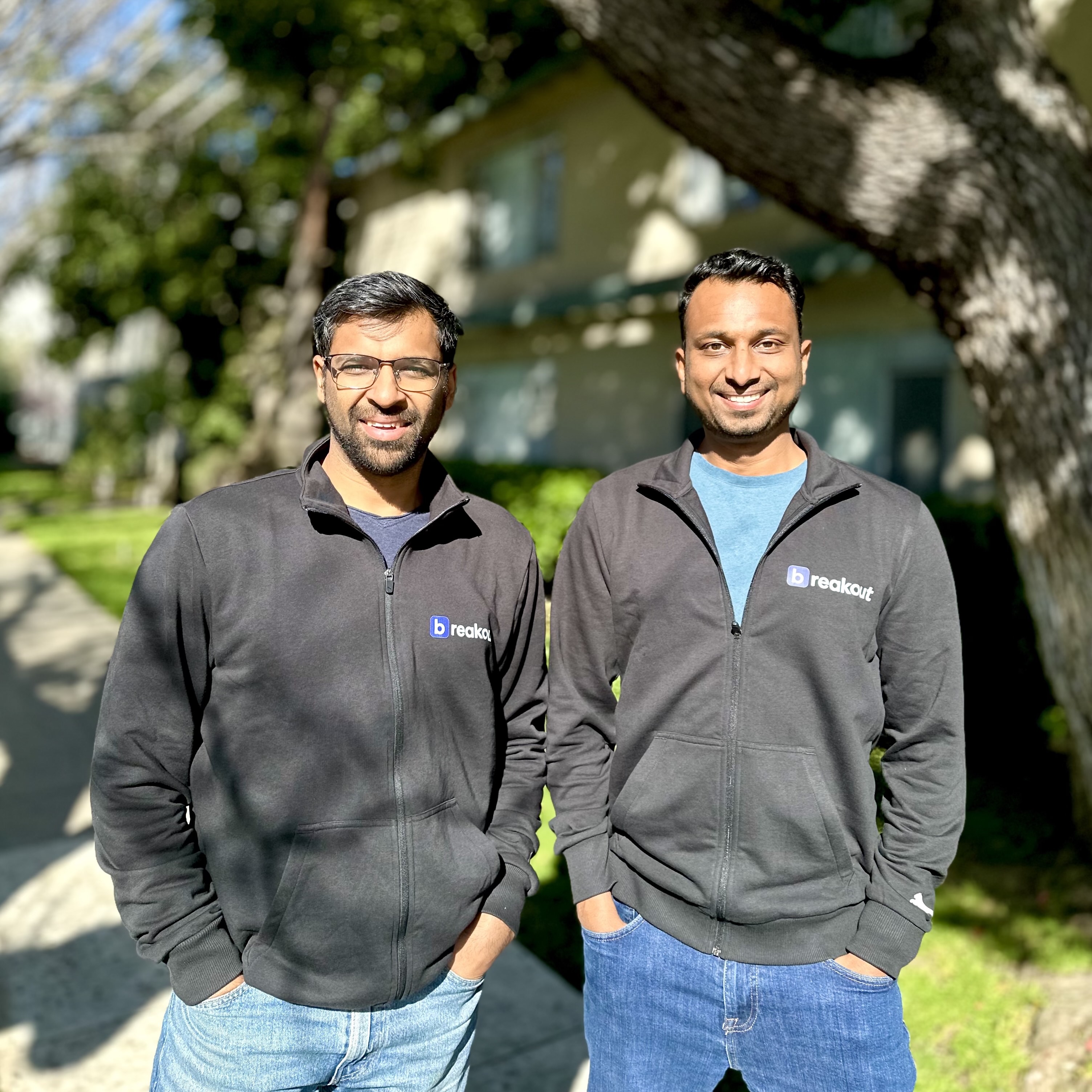 Breakout co-founders Sachin Gupta and Hitesh Aggarwal standing outdoors in company jackets